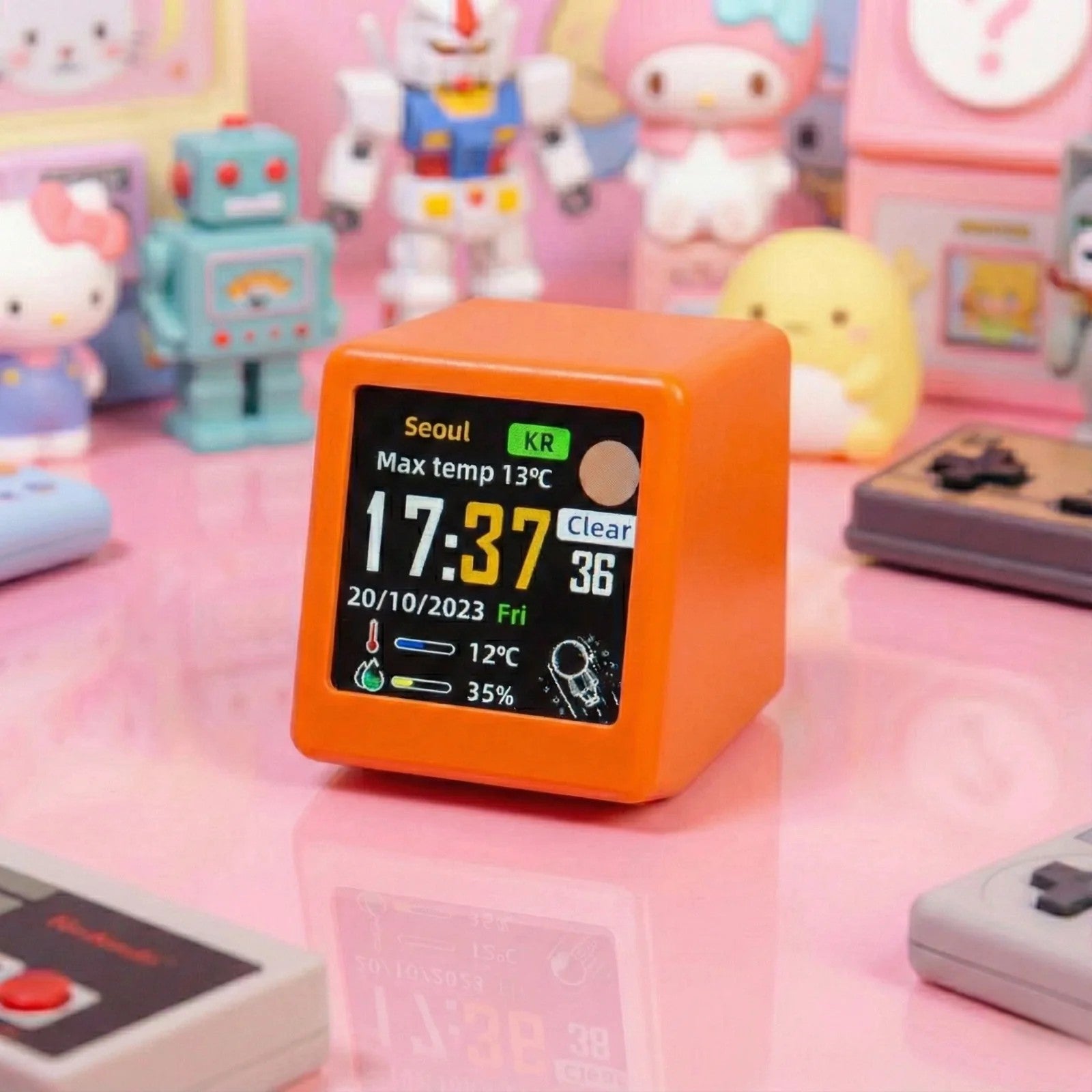 Orange digital clock with weather display on a pink surface with toys in the background
