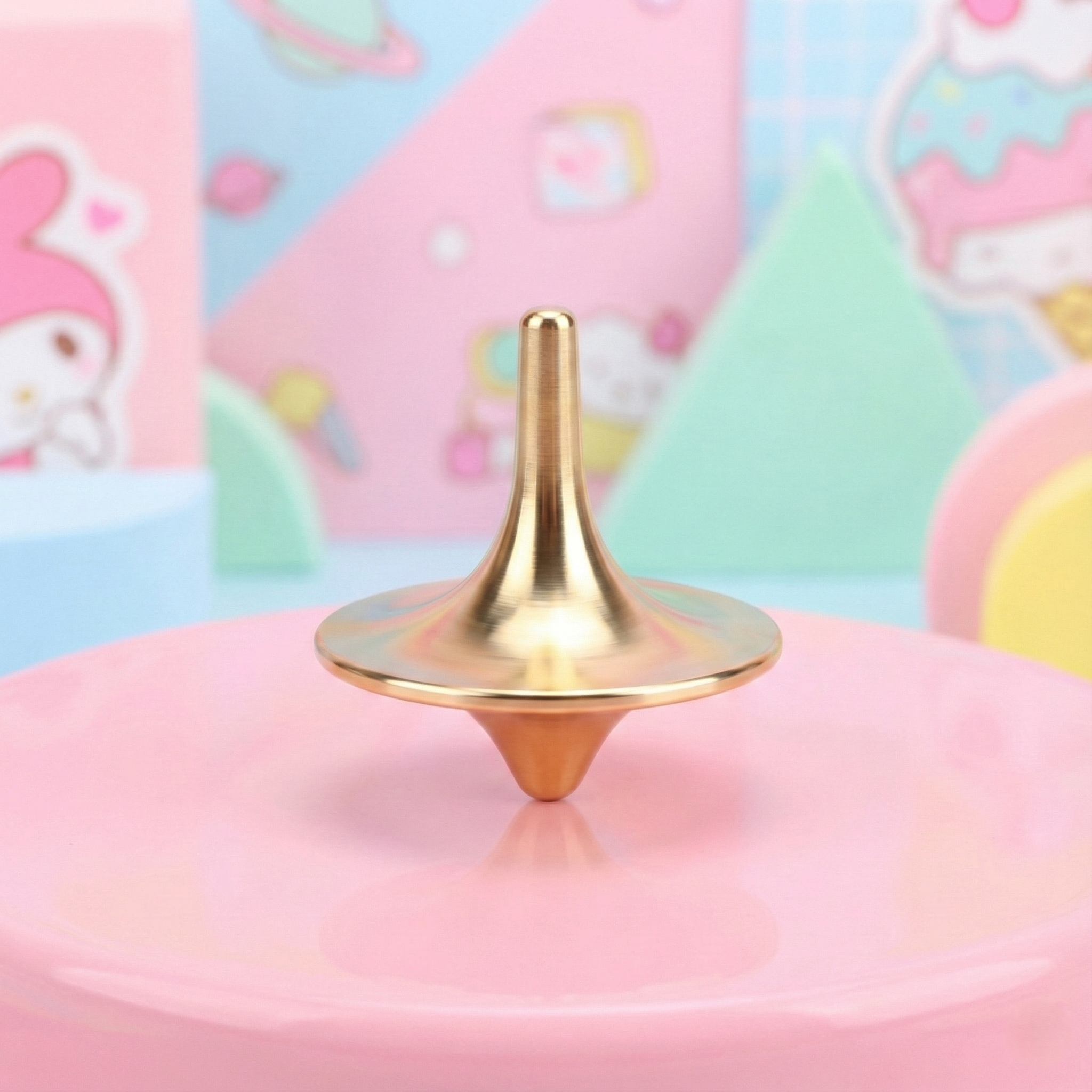 Gold spiky toy on a pink surface with a colorful, cartoon-like background