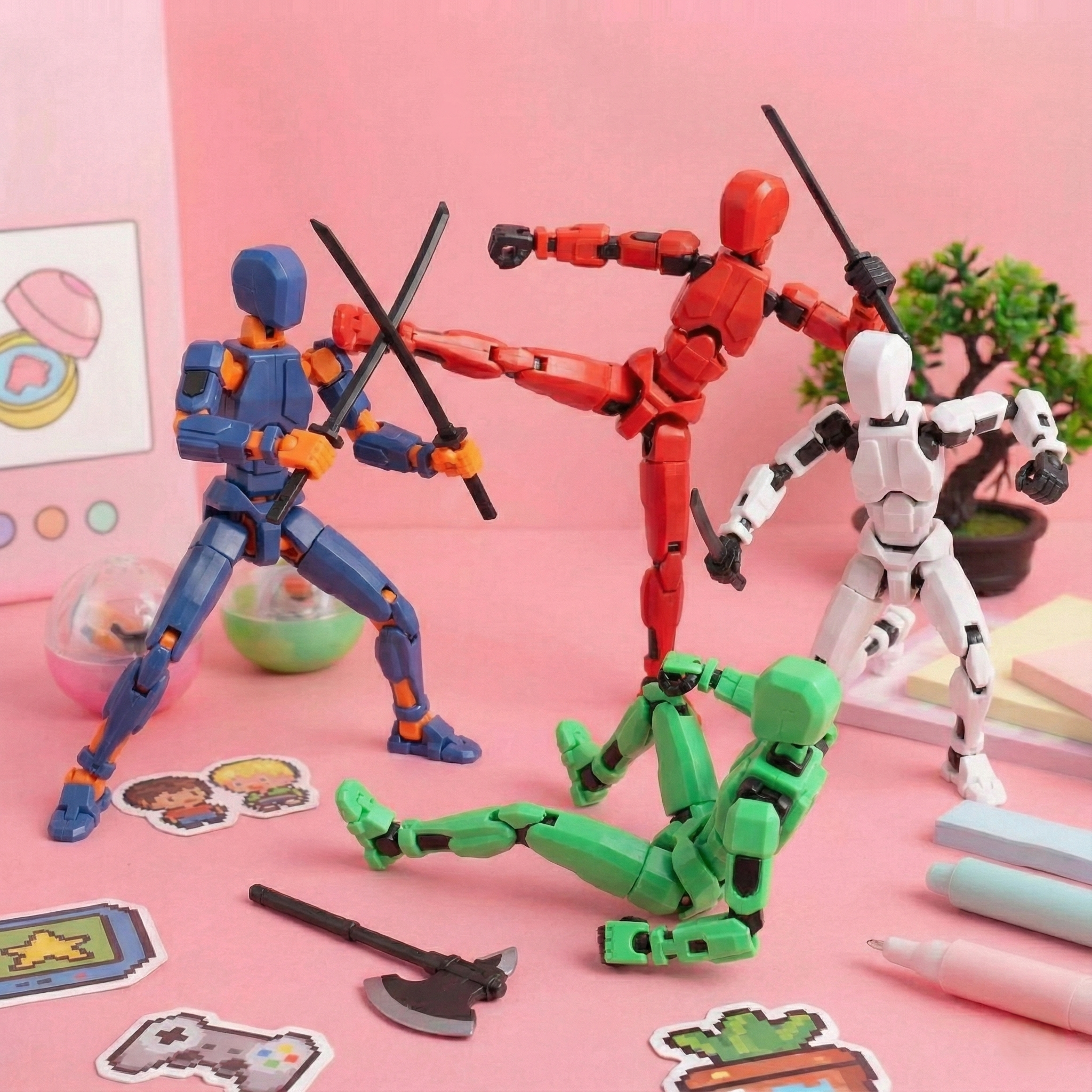 Toy figures on a pink surface with stationery items